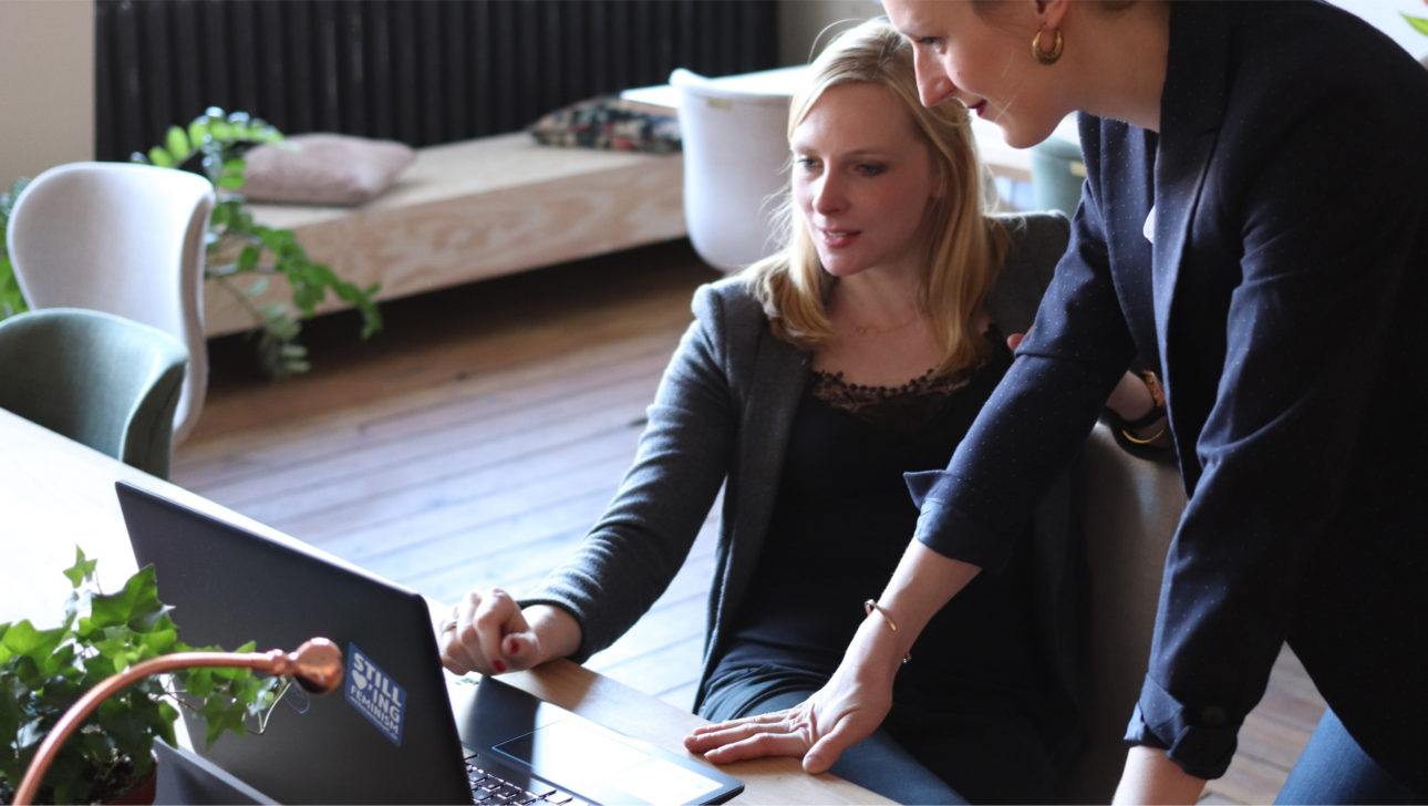 adults having a conversation by a computer