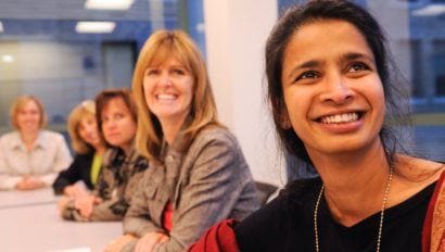 women at an event smiling