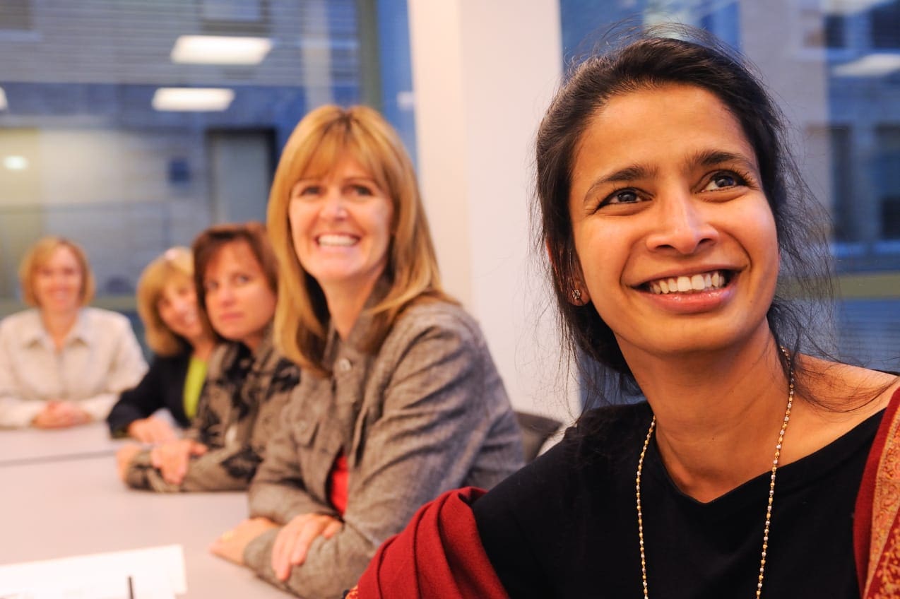 women at an event smiling