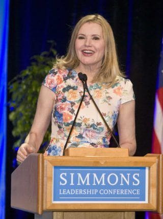 Geena Davis speaking at podium.