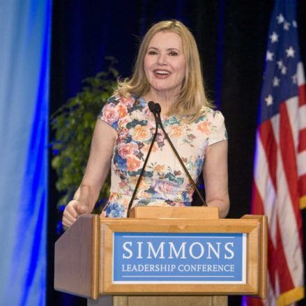 Geena Davis speaking at podium.