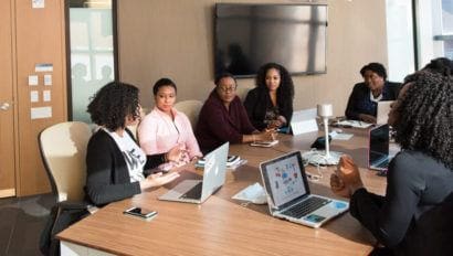 Women meeting around office table