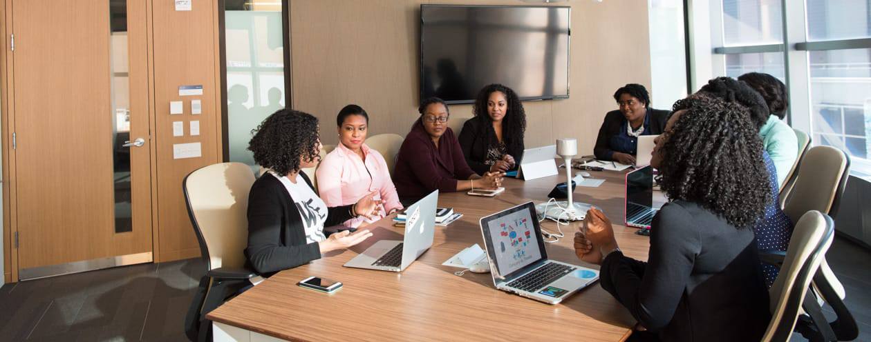 Women meeting around office table