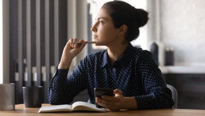 Woman looks off in reflection