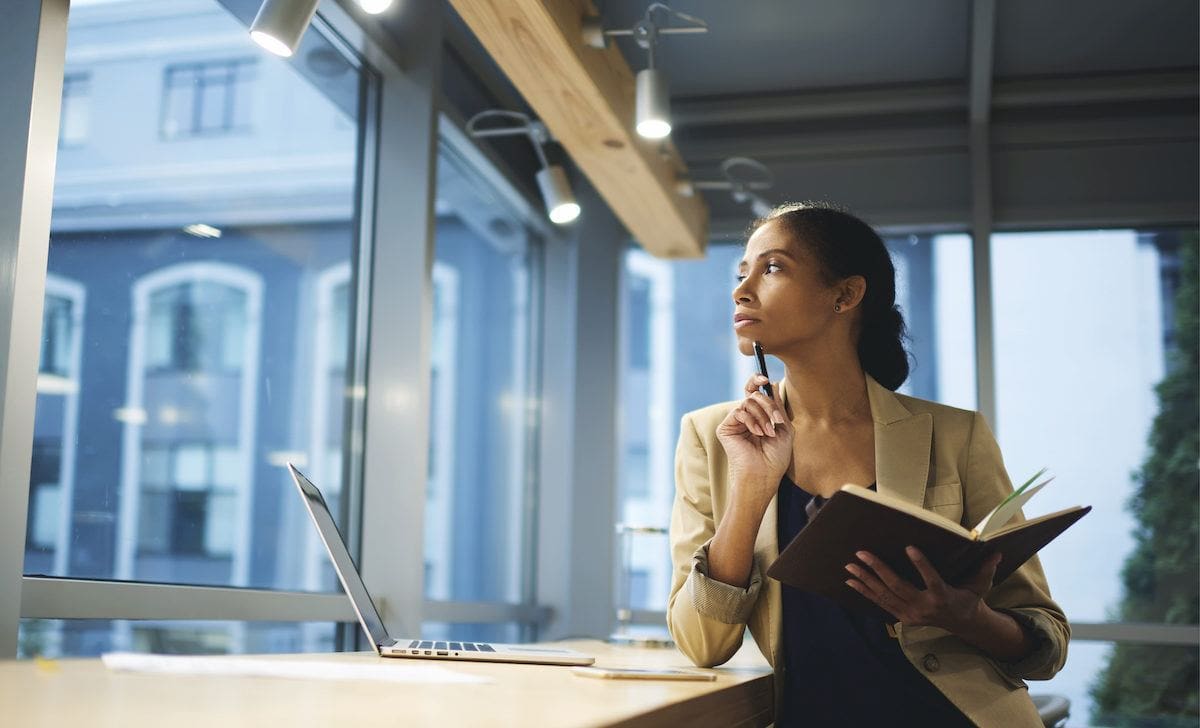 professional woman looking out office window