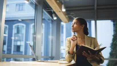 professional woman looking out office window