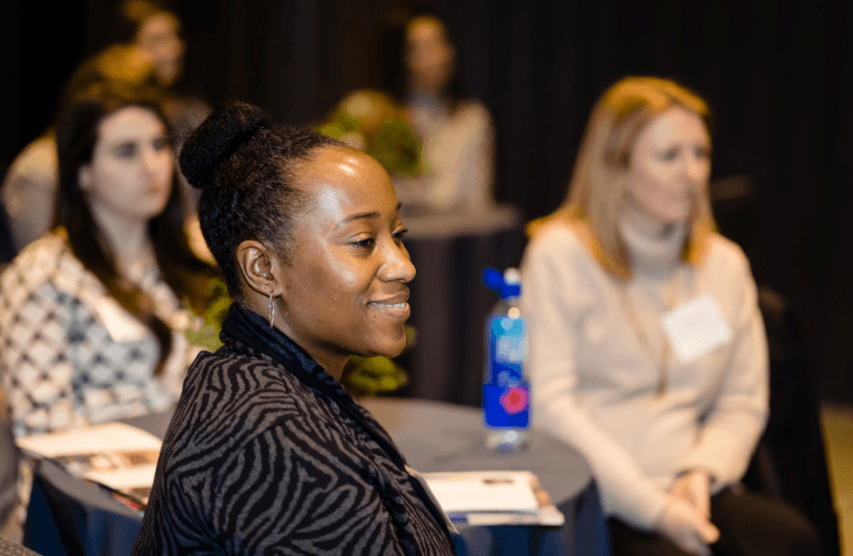 women smiling at conference