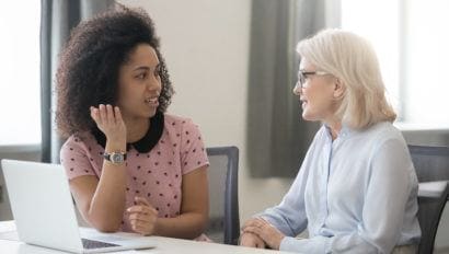 older woman mentoring younger woman in an office