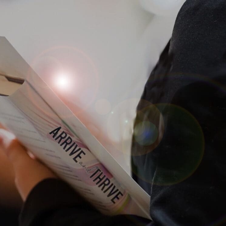 Woman holding the Arrive and Thrive book